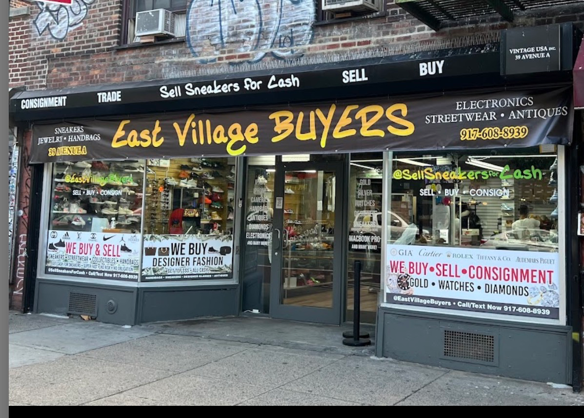 Inside East Village Buyers storefront on Avenue A showing gold jewelry and designer goods