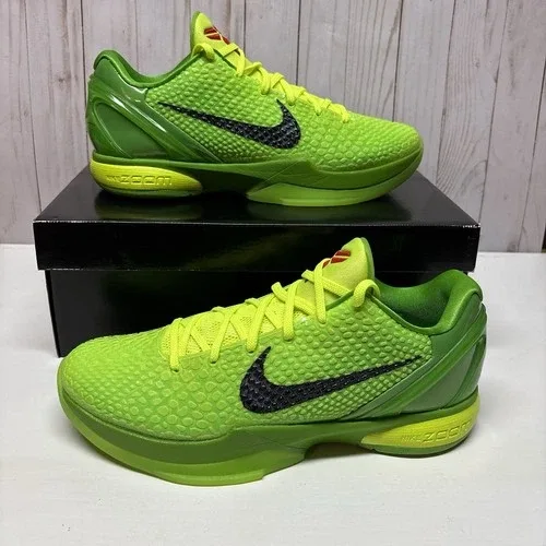 A pair of Nike Kobe sneakers displayed on a wooden tabletop.