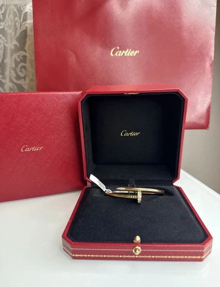 Gold designer bracelet in a Cartier presentation box