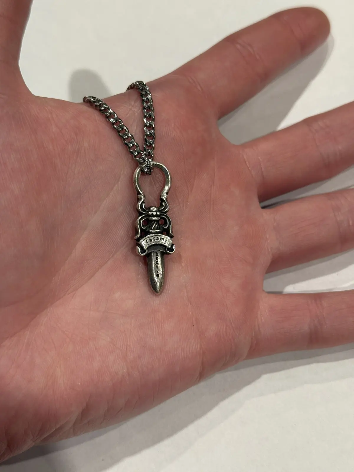 Chrome Hearts silver dagger pendant on a chain