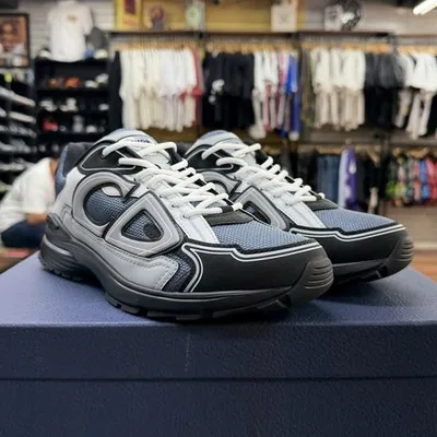 Gray and navy Dior B22 sneakers on a Dior box