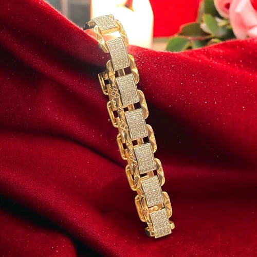 Yellow gold link bracelet with pavé-set diamond panels on red velvet