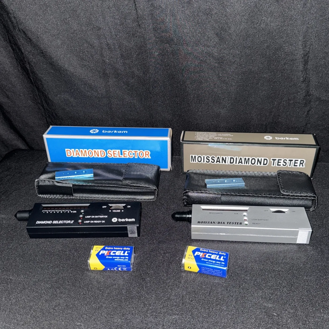 A thermal diamond selector and a moissanite/diamond tester with their cases and batteries
