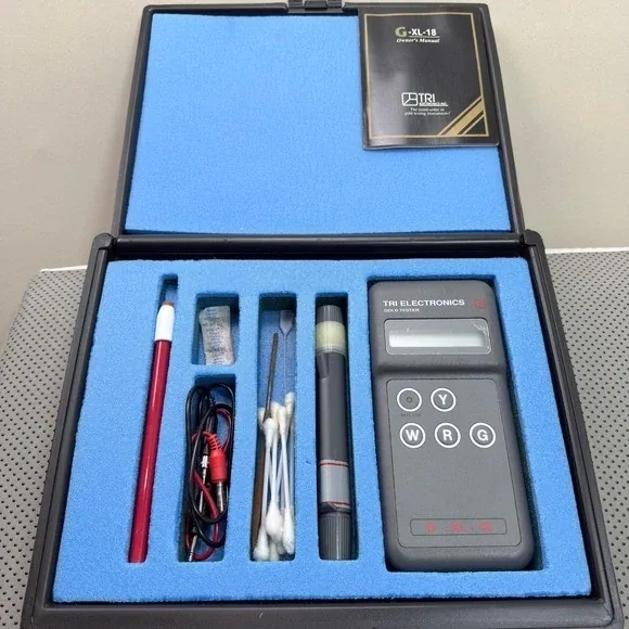 Tri Electronics electronic gold tester kit with probe, gel, cotton swabs and color selection buttons in a foam-lined case
