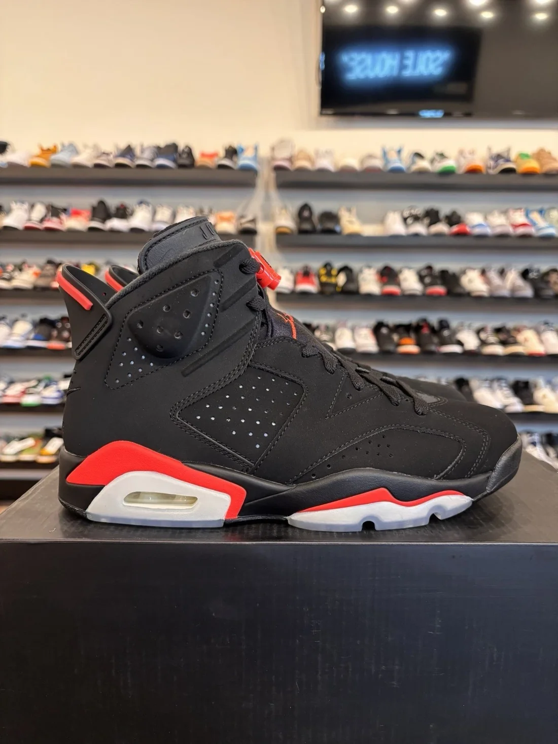 Air Jordan 6 Infrared black and red sneakers on display shelf