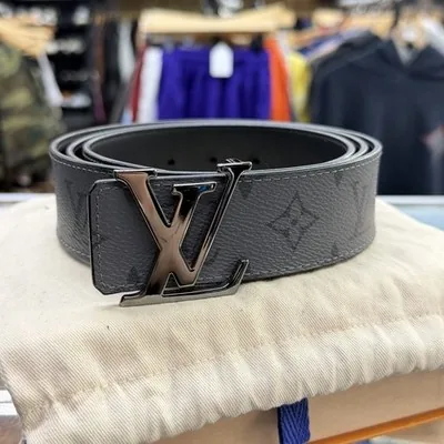 Louis Vuitton Initiales belt with a silver LV buckle on its dust bag
