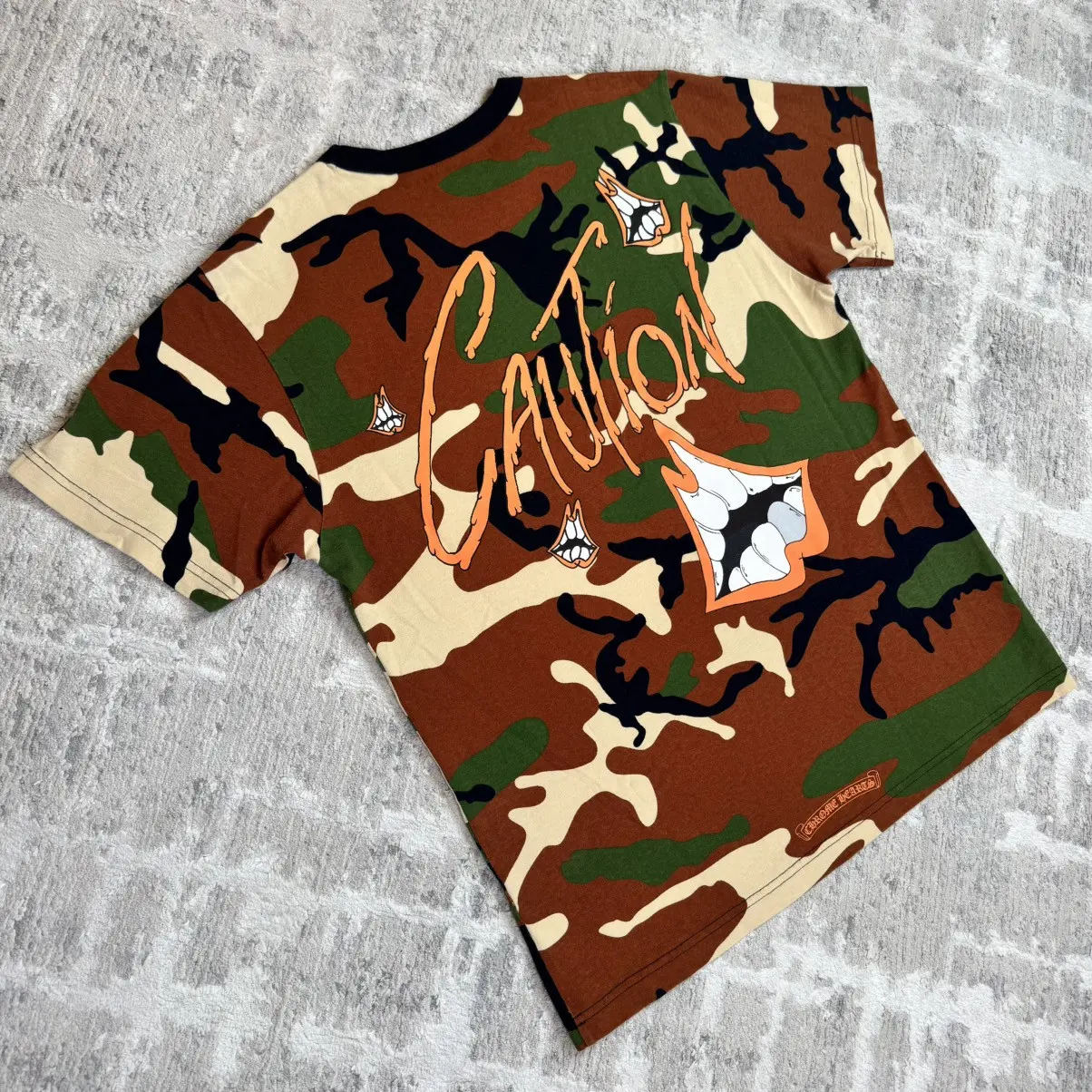 Chrome Hearts x Matty Boy camo t-shirt with teeth graphic and Caution lettering