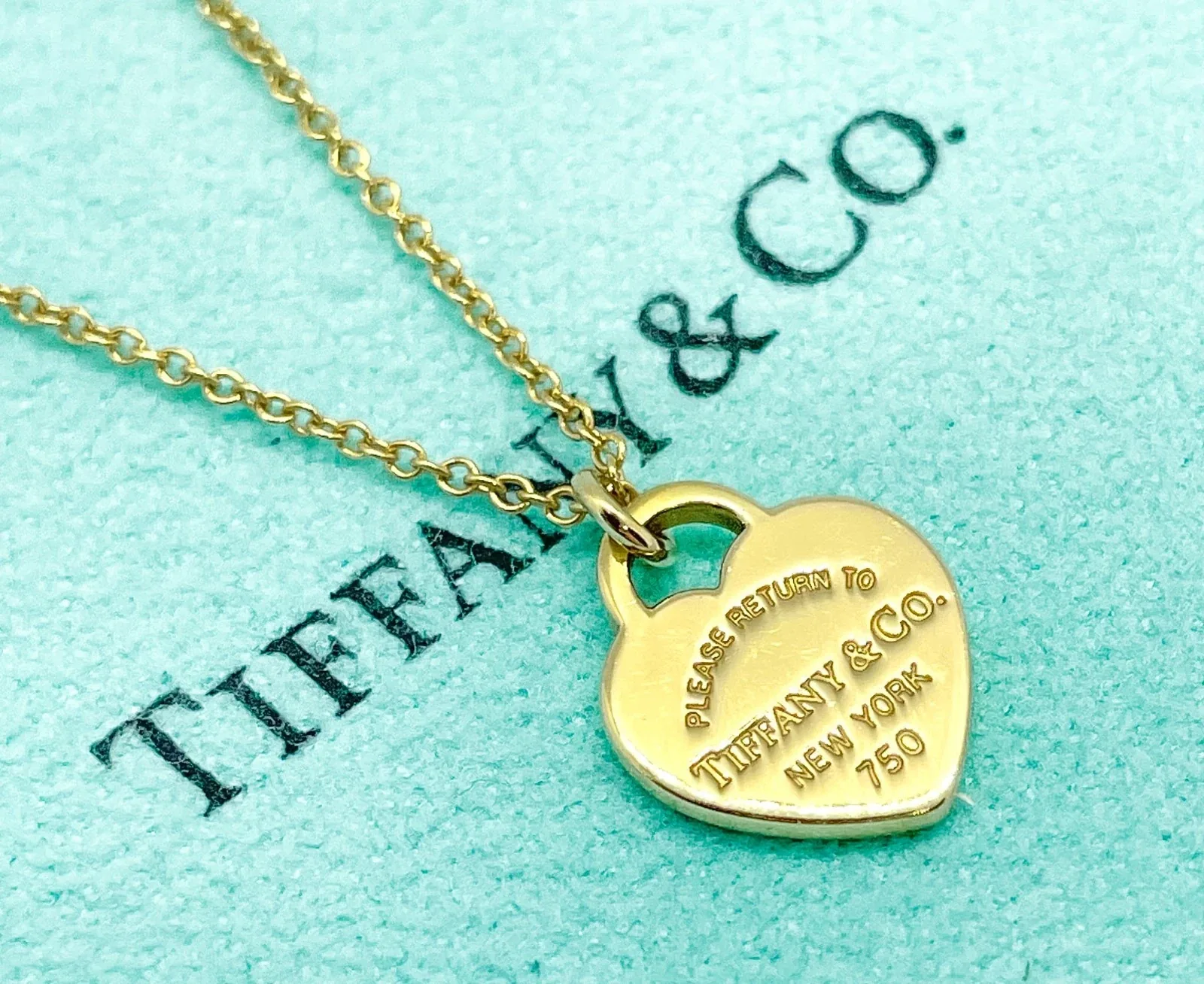 Gold designer necklace in a Tiffany and Co. box