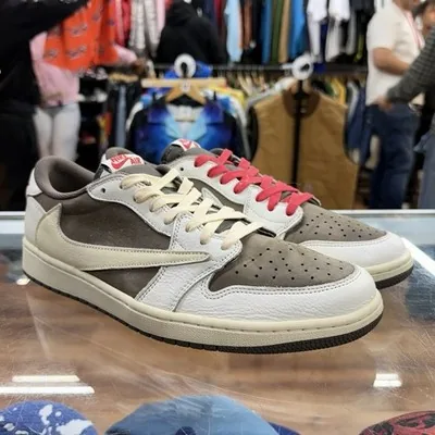 Travis Scott x Air Jordan 1 Low sneakers in the reverse mocha colorway on the counter at East Village Buyers