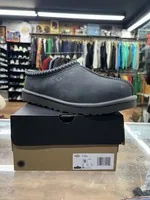 Black UGG Tasman slippers on their box