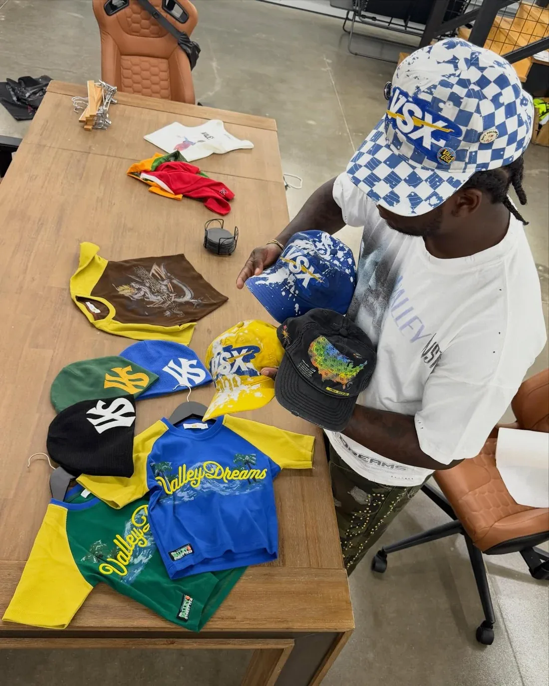 Vale Forever Valley Dreams caps, bandanas, and graphic tees laid out on a table