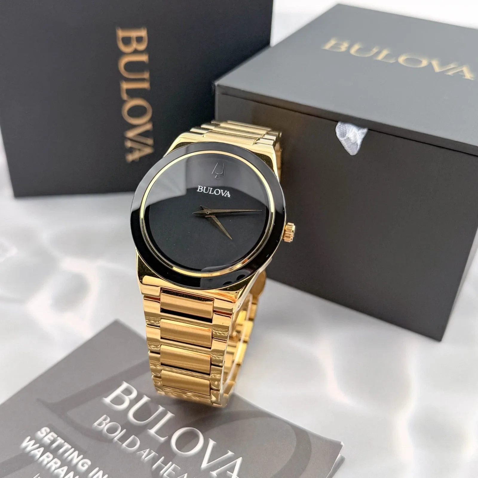 Gold-tone Bulova watch with its original box
