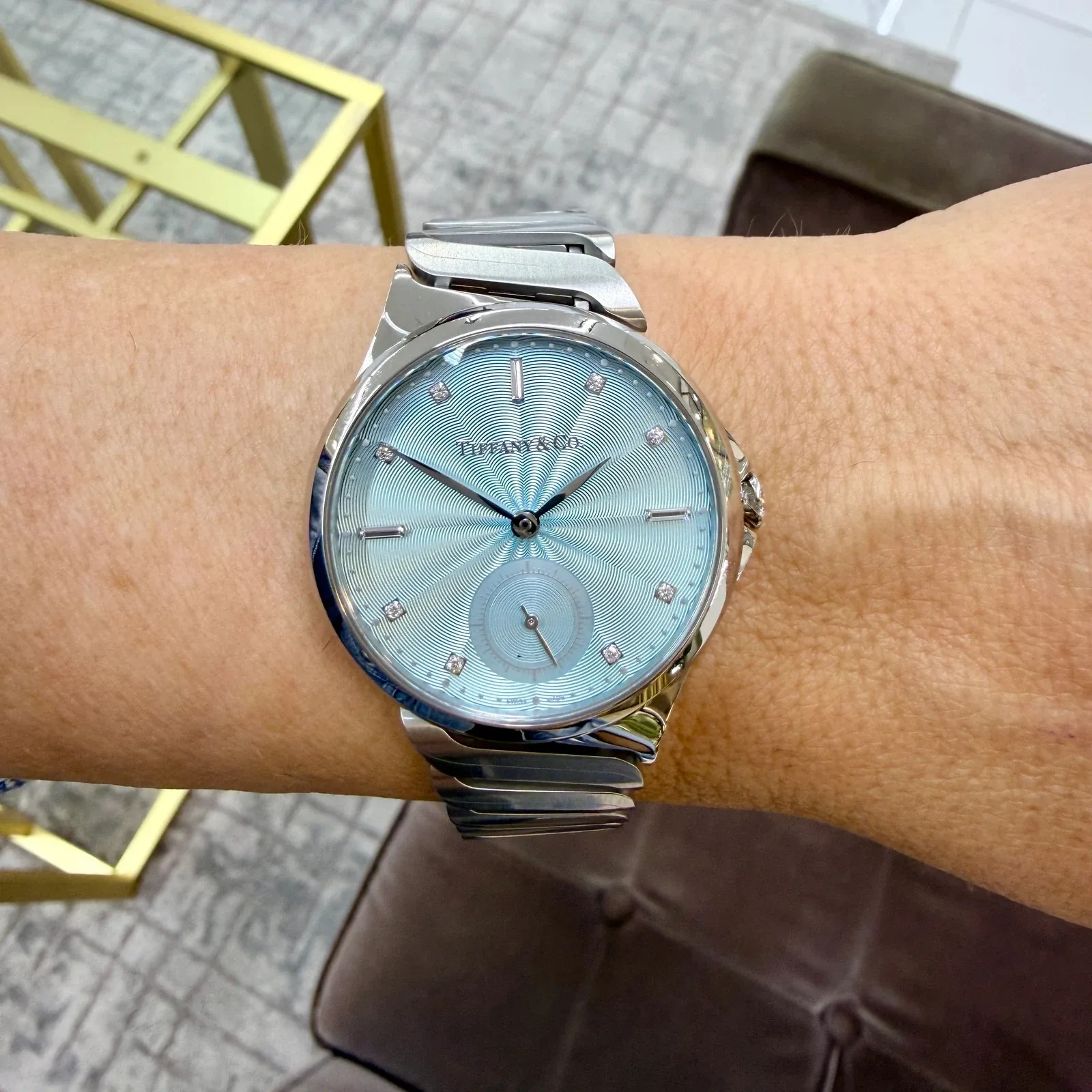 Tiffany and Co luxury watch with a blue dial on a wrist